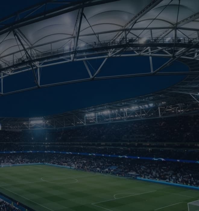 Floodlit stadium roof and pitch during an evening match